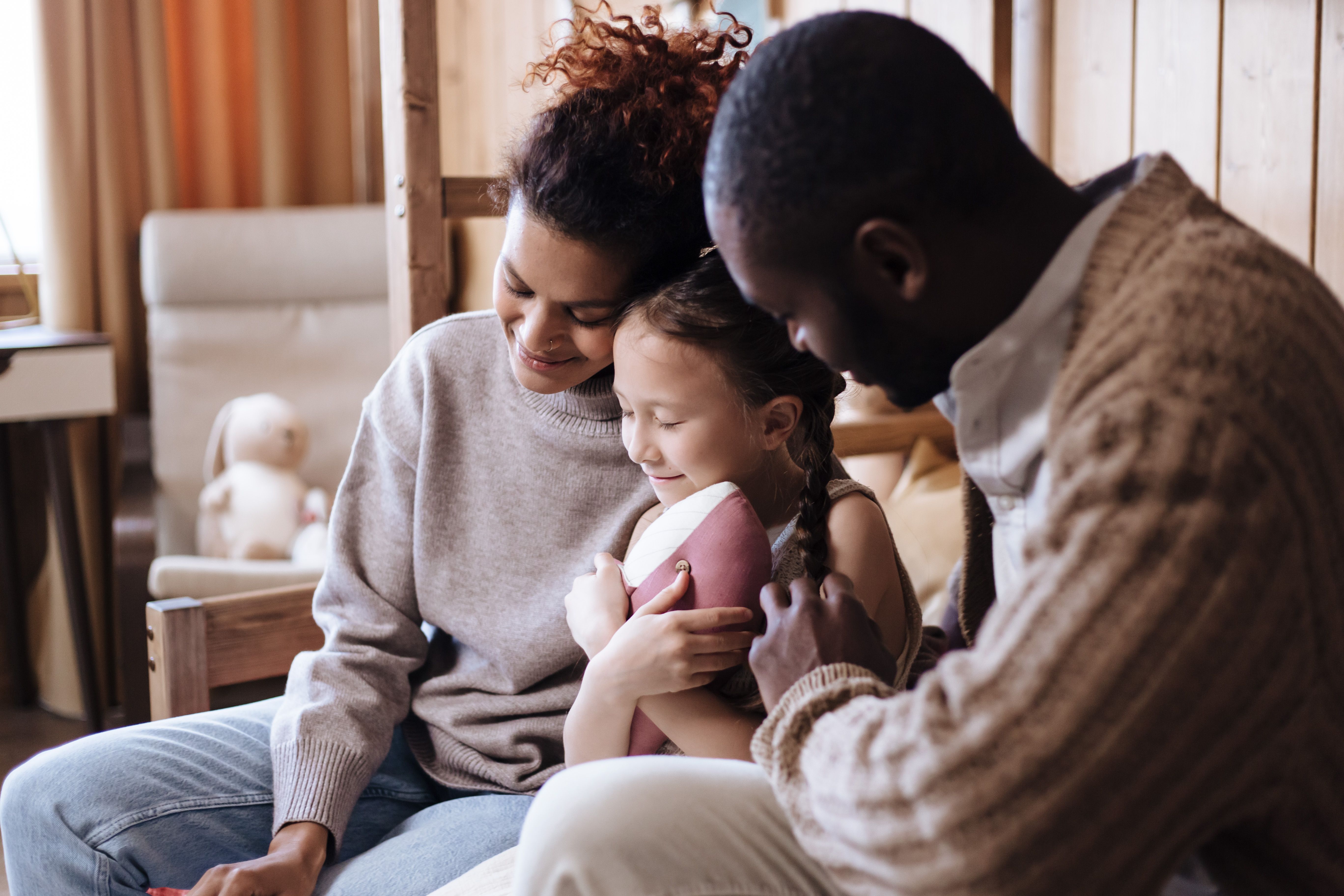 Estate Planning and Wills for Seattle Parents of Neurodivergent Kids || a photo of two parents sitting down with their child between them