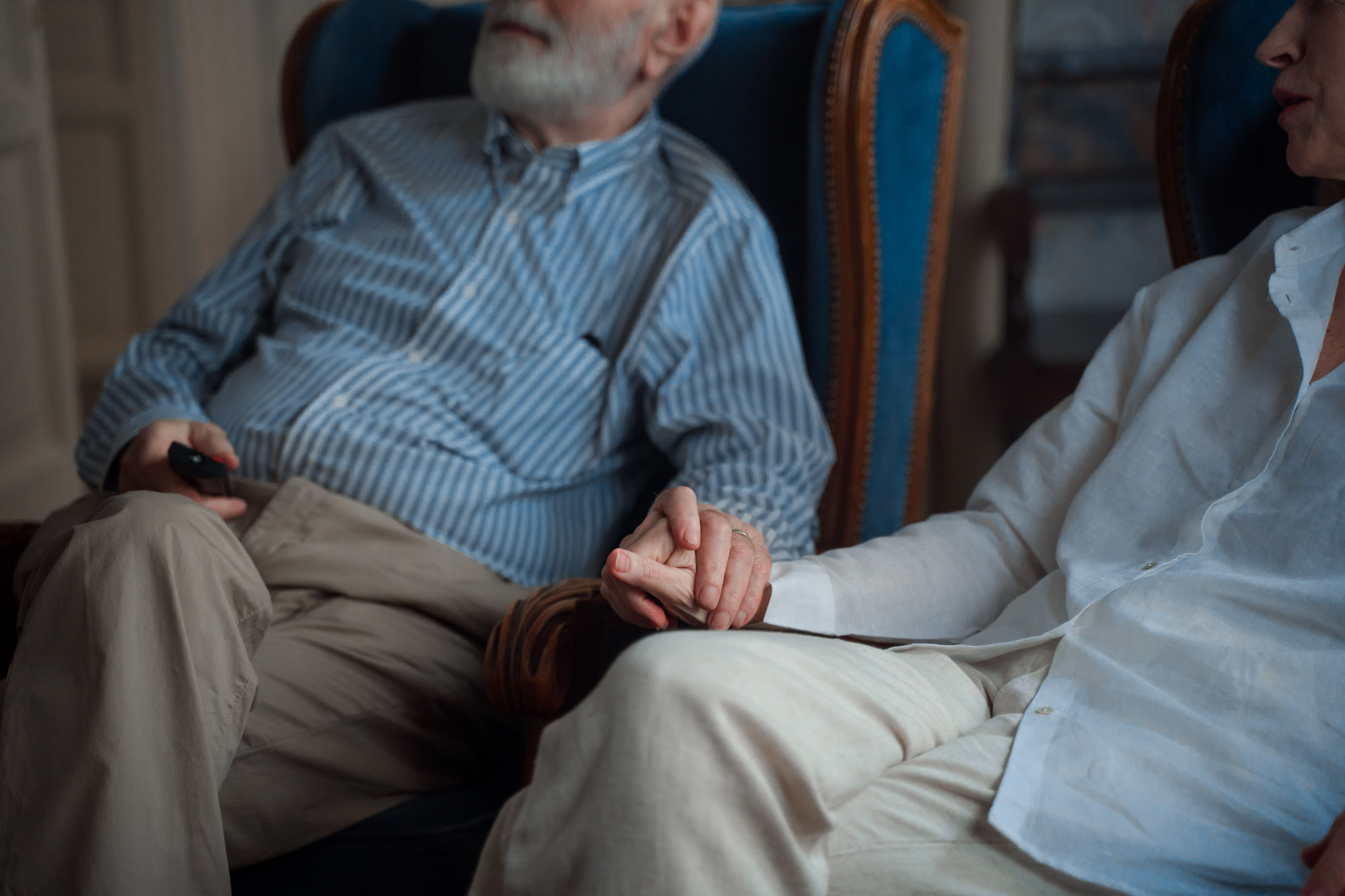 Seattle Homeowners Guide to Long-Term Care Planning | Older Couple At Home Holding Hands